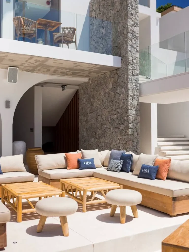 Contemporary recycled teak outdoor lounge furniture with sofas, tables, and stools at Fira Beach Club, Phuket, Thailand
