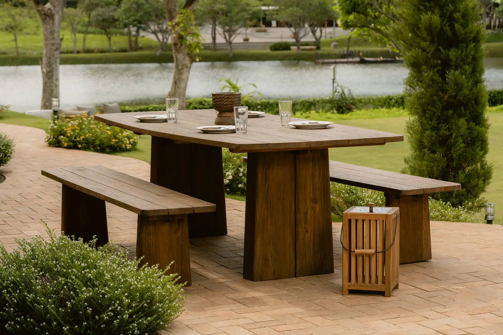Reclaimed teak outdoor dining table with bench set for resort garden area