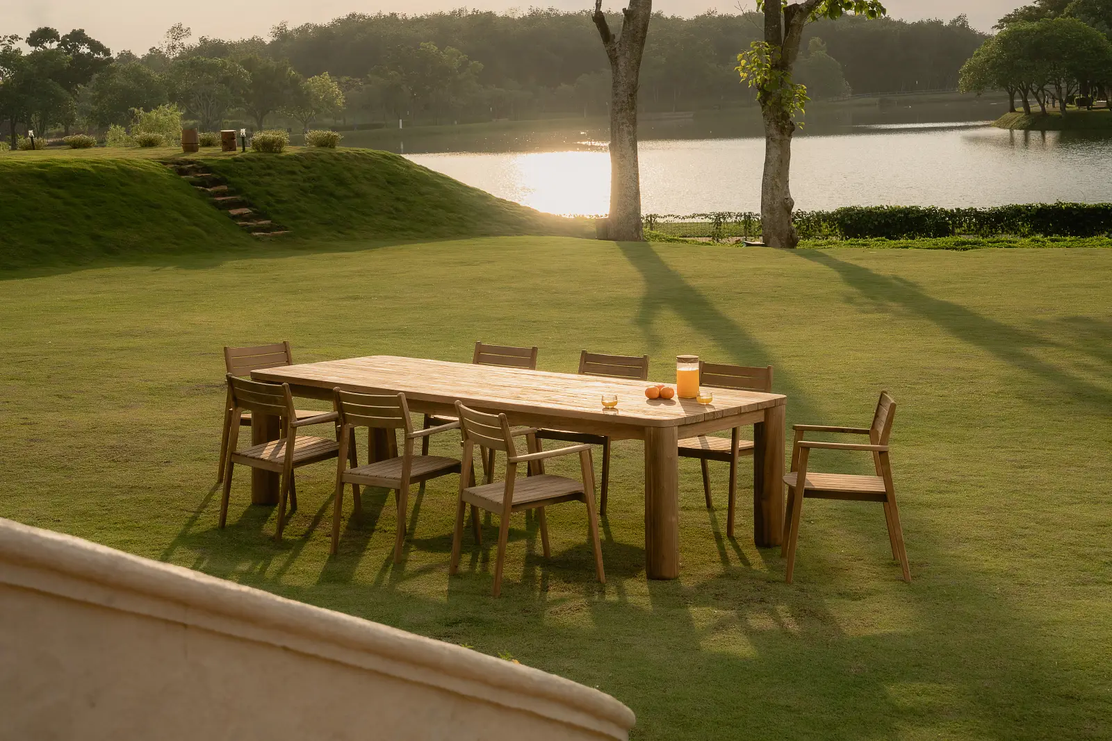 Reclaimed teak outdoor dining table and chairs for lakeside resort garden dining