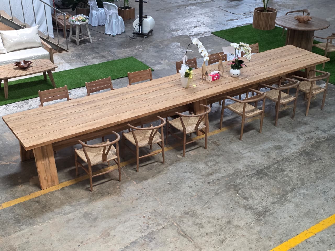 6-meter reclaimed teak banquet table with woven-seat dining chairs, styled for large event seating